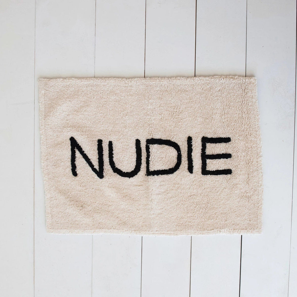 Creative Co-op Creative Co-op 40"L x 27"W White Cotton Tufted Bath Mat with "NUDIE" in Black - Little Miss Muffin Children & Home