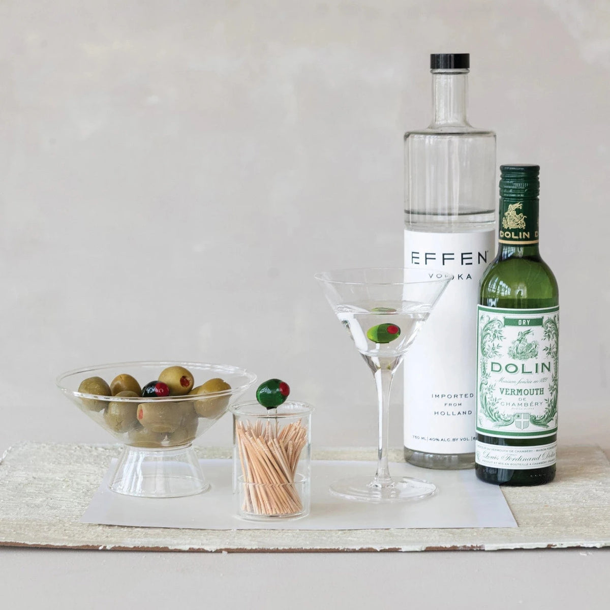 stemmed martini glass with olive inside